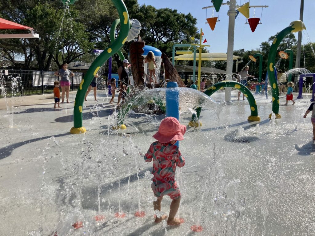 baby at kiwanis sprayground splash pad in dunedin fl