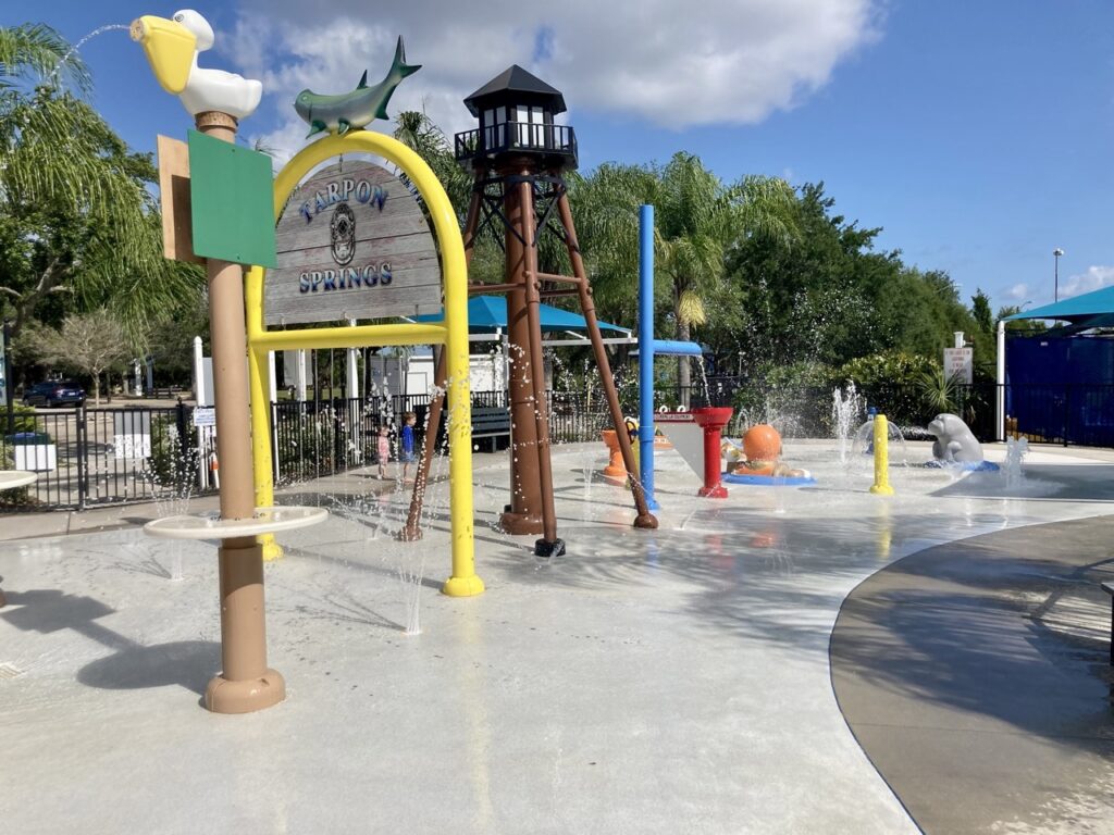 splash pad with fountains on but no kids in the picture