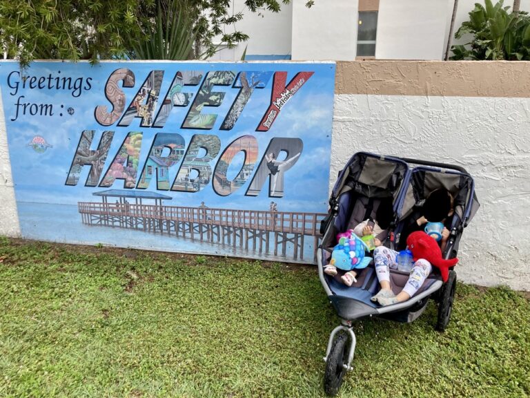 greetings from safety harbor fl mural with stroller in front of it