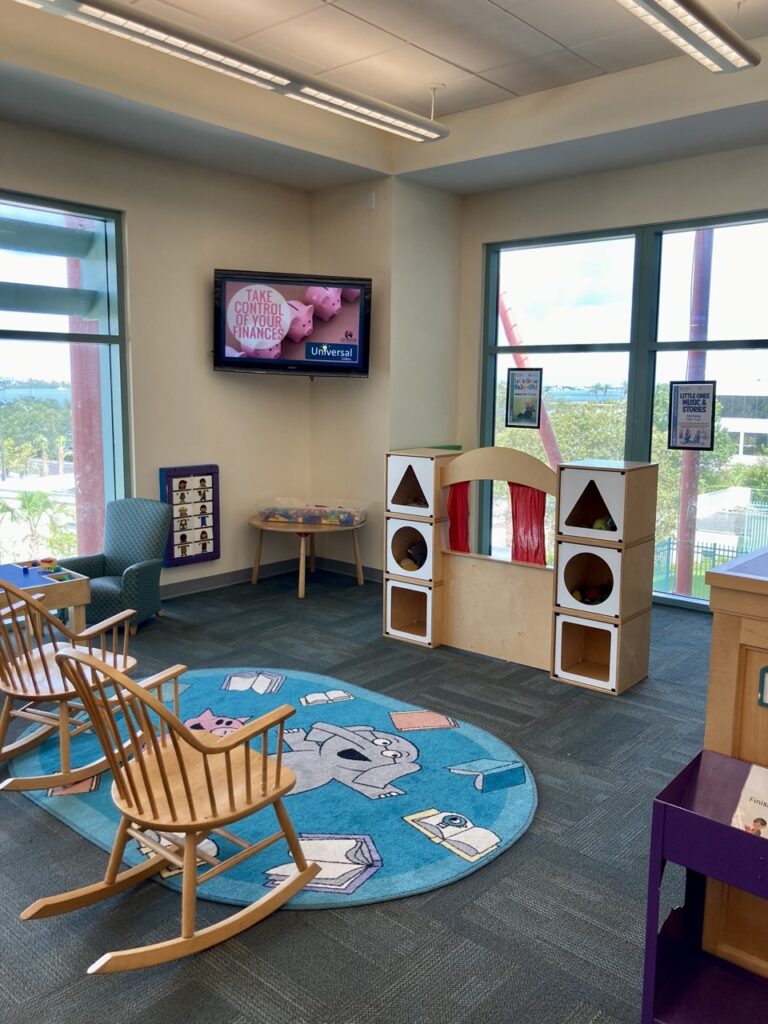 kids area at the clearwater library main branch showing two rocking chairs and a puppet stage