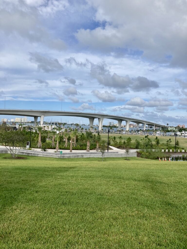 view of coachman park in clearwater florida with green space and causeway in the distance