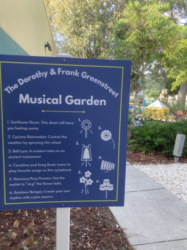 sign for the musical garden at palm harbor library, describing the musical instruments hidden throughout the garden