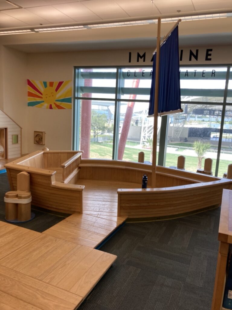 children's library area at the clearwater library main branch, with a big wooden boat kids can climb on