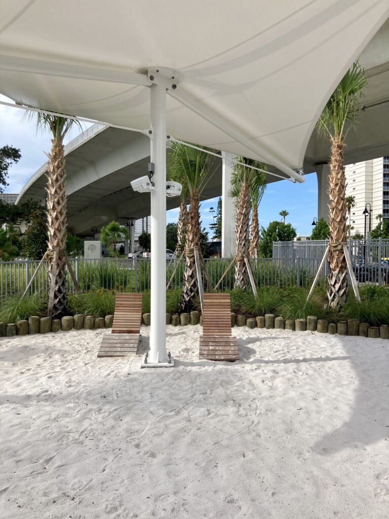 beach lounge chairs in a sand feature at coachman park in clearwter