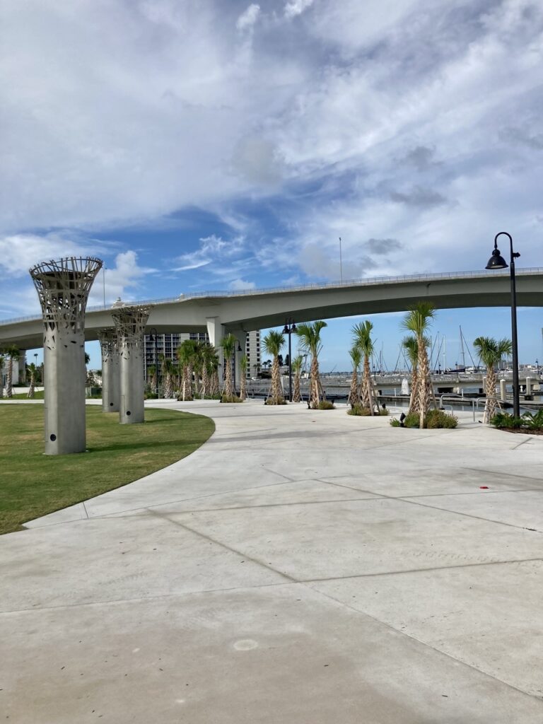 sidewalk at the new coachman park in clearwter with the causeway and clouds in the background