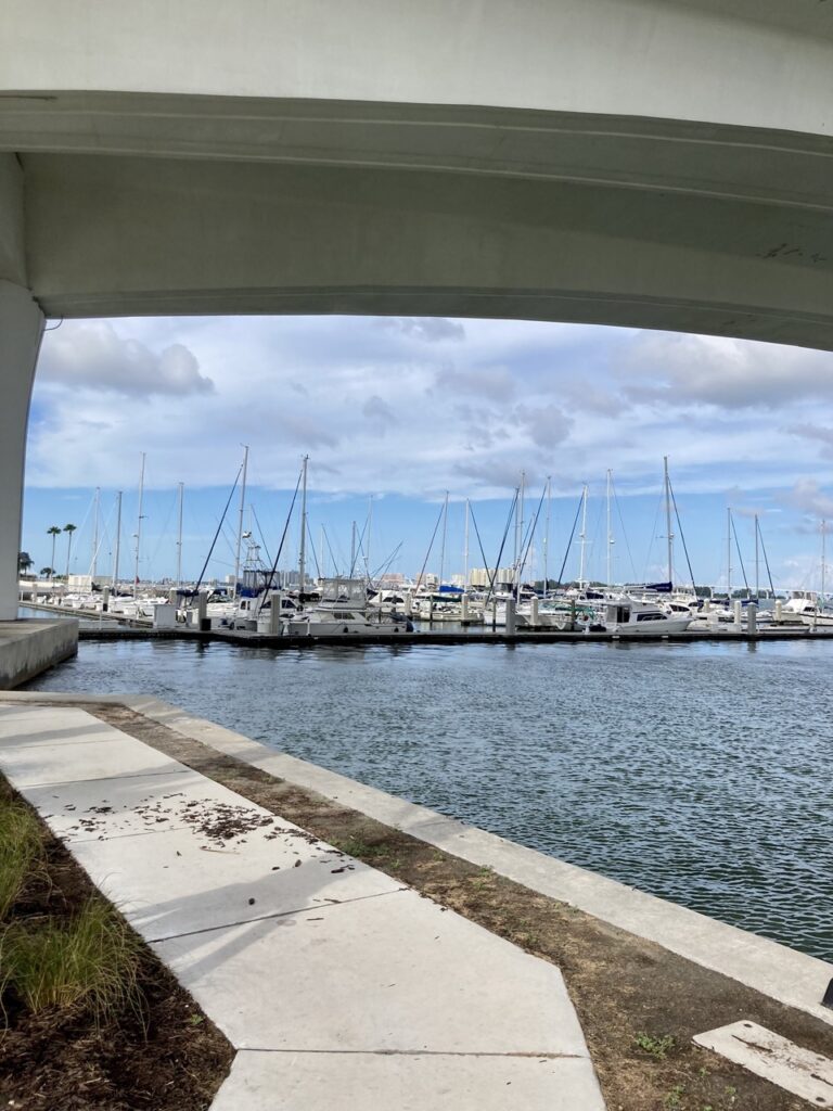 waterfront sidewalk at coachman park with boat marina in the background