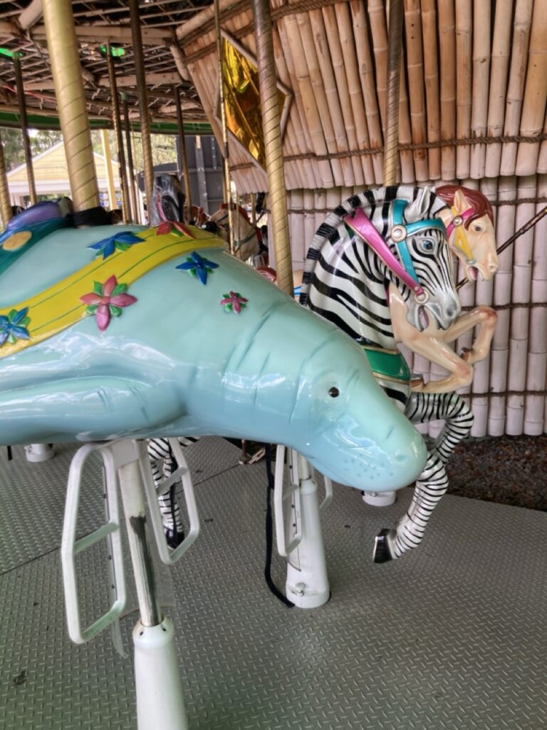 Manatee and zebra carousel animals up at close