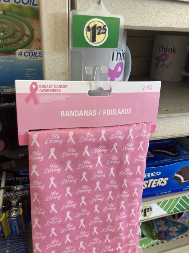 This picture shows a breast cancer themed pink bandana hanging on the shelf at the dollar tree
