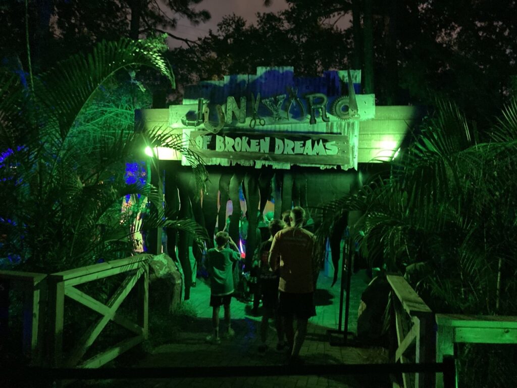 entrance to the zootampa creatures of the night haunted house, with green lights illuminating it