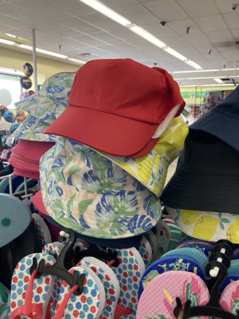 red hat on top of other hats at the dollar tree