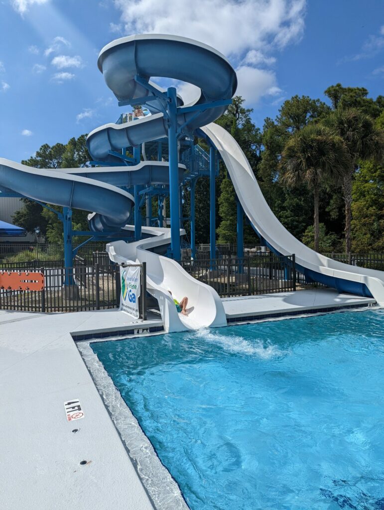 Twisting water slide going into a pool corner