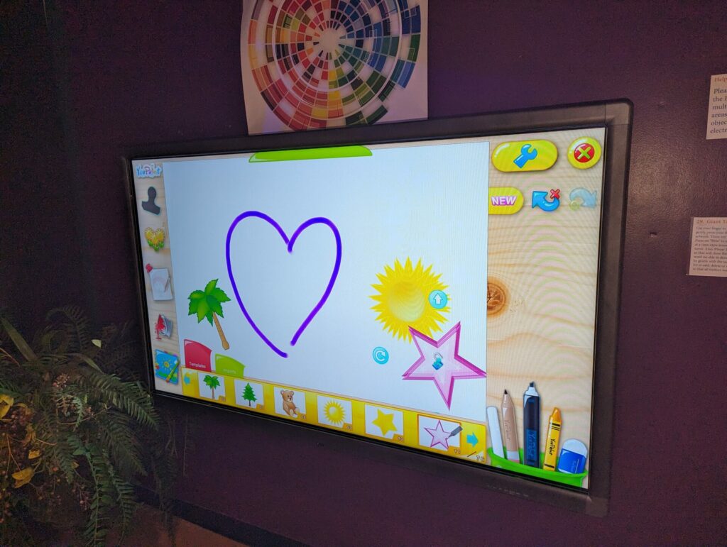 Draw and stamp on giant wall touch screen.