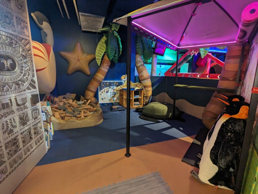 preschool play area at the dfac children's art museum with blocks and beach-y themed decor around the space