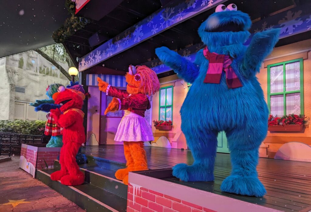 Elmo and Friends in scarfs singing