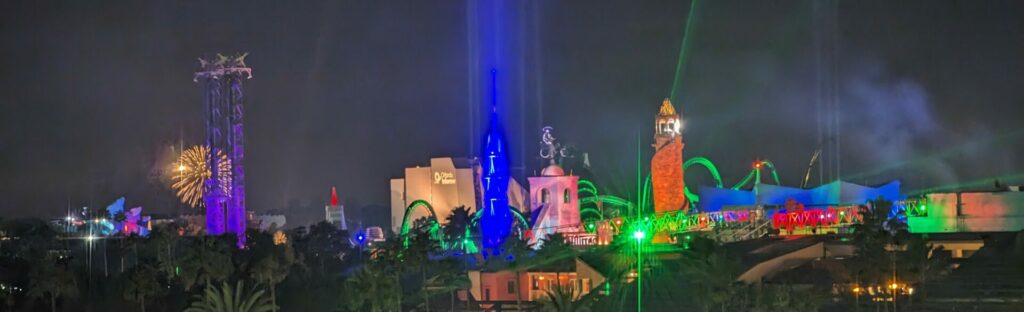 skyline of a theme park lit up at night
