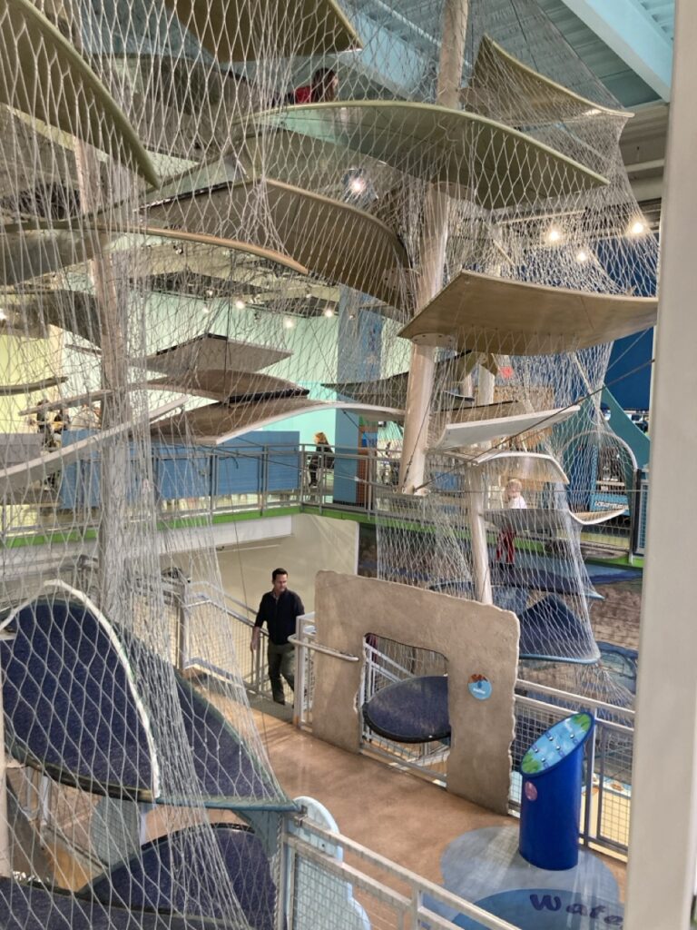 Climbing structures with netting all around them over the second floor for kids to climb at the Glazer Children's Museum