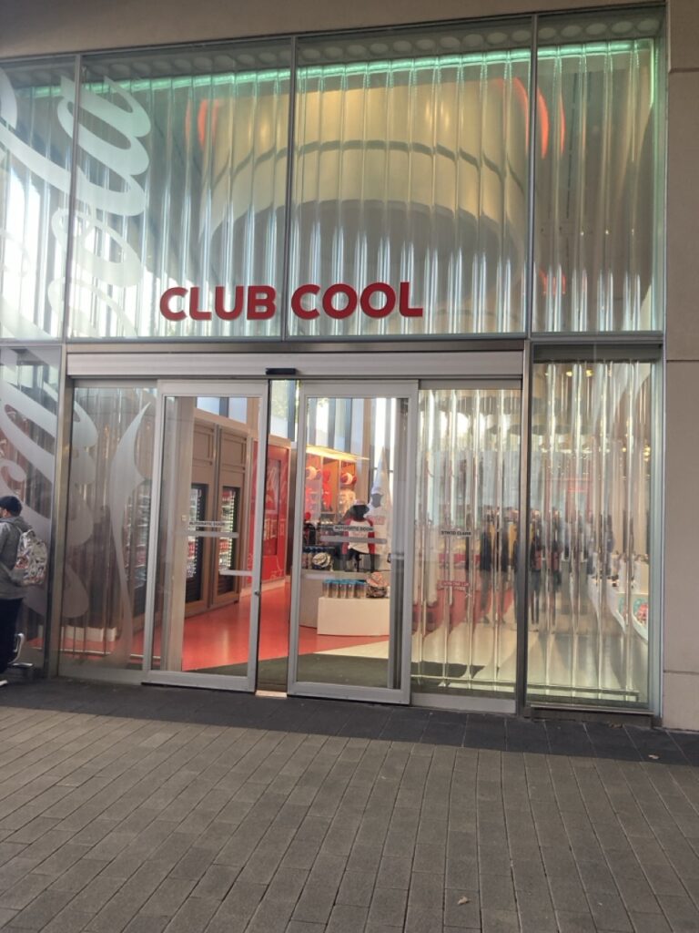 Door to a store with the sign above that says Cool Club at Epcot