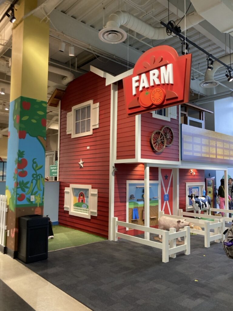 Farm play area at the Glazer Children's museum that looks like a barn