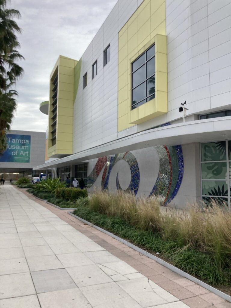 Outside of the glazer children's museum in Tampa with the sidewalk leading up to it. 