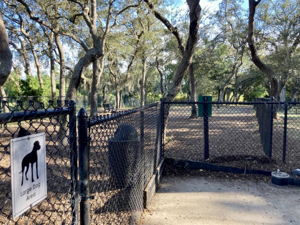 Fence around the large dog area of the Safety Harbor City Park dog park with the dog area in the background