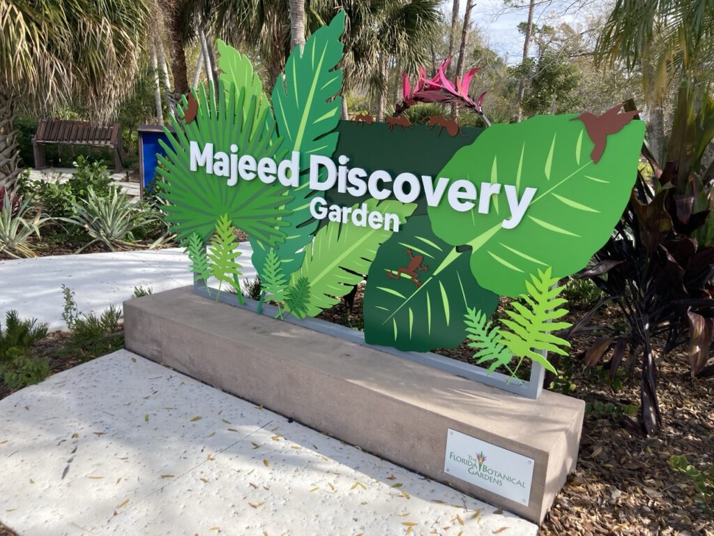 the sign for the majeed discovery garden at the florida botanical garden