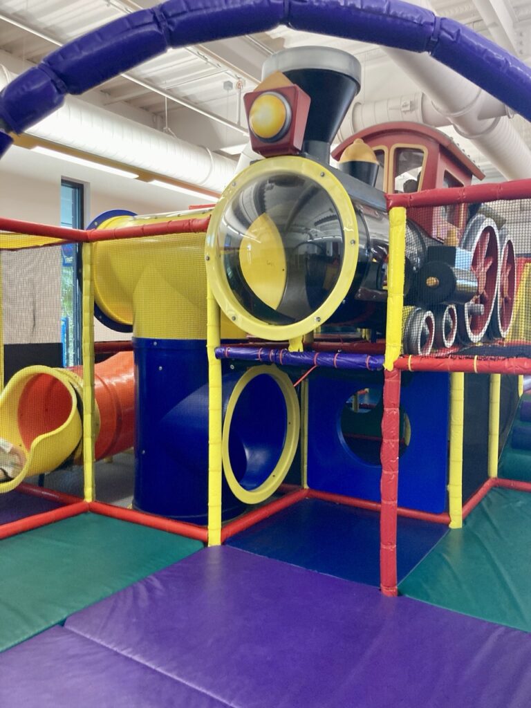 playworld indoor playground in largo. colorful flooring and playground climbing structures that look like a train