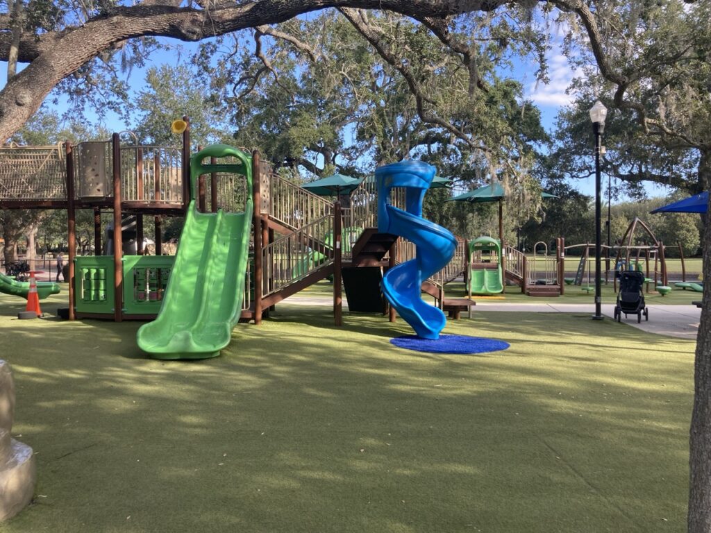 Largo central park playground with green slides and a blue twisty slide
