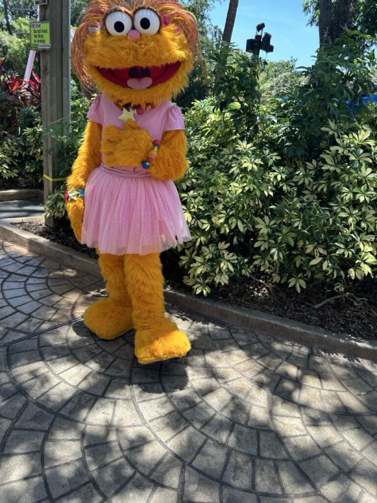sesame street zoe character at busch gardens standing by bushes